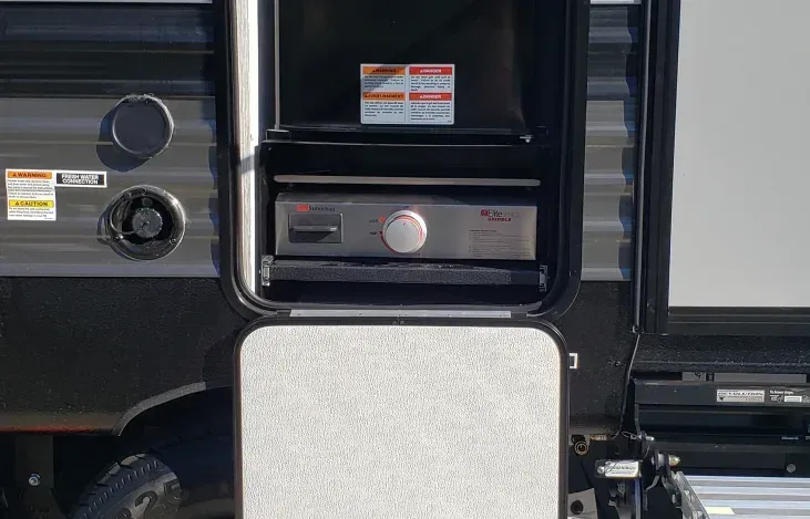 There is a microwave oven in the back of a trailer.