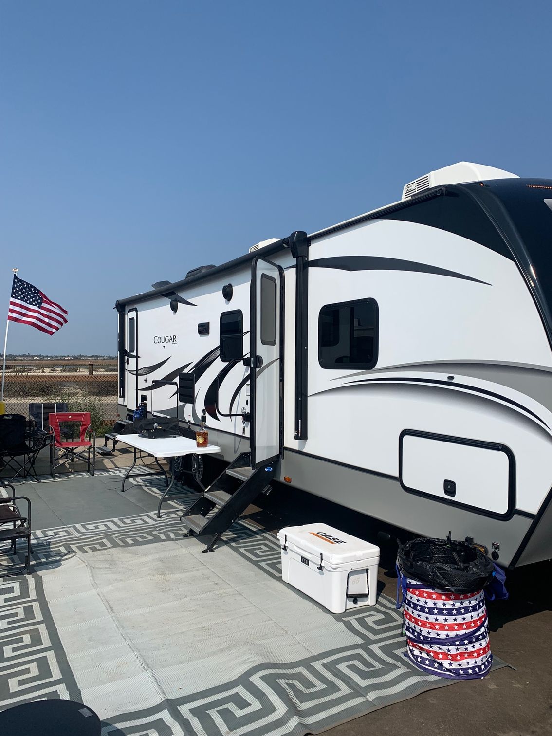 a couple of rvs parked next to each other on a patio .
