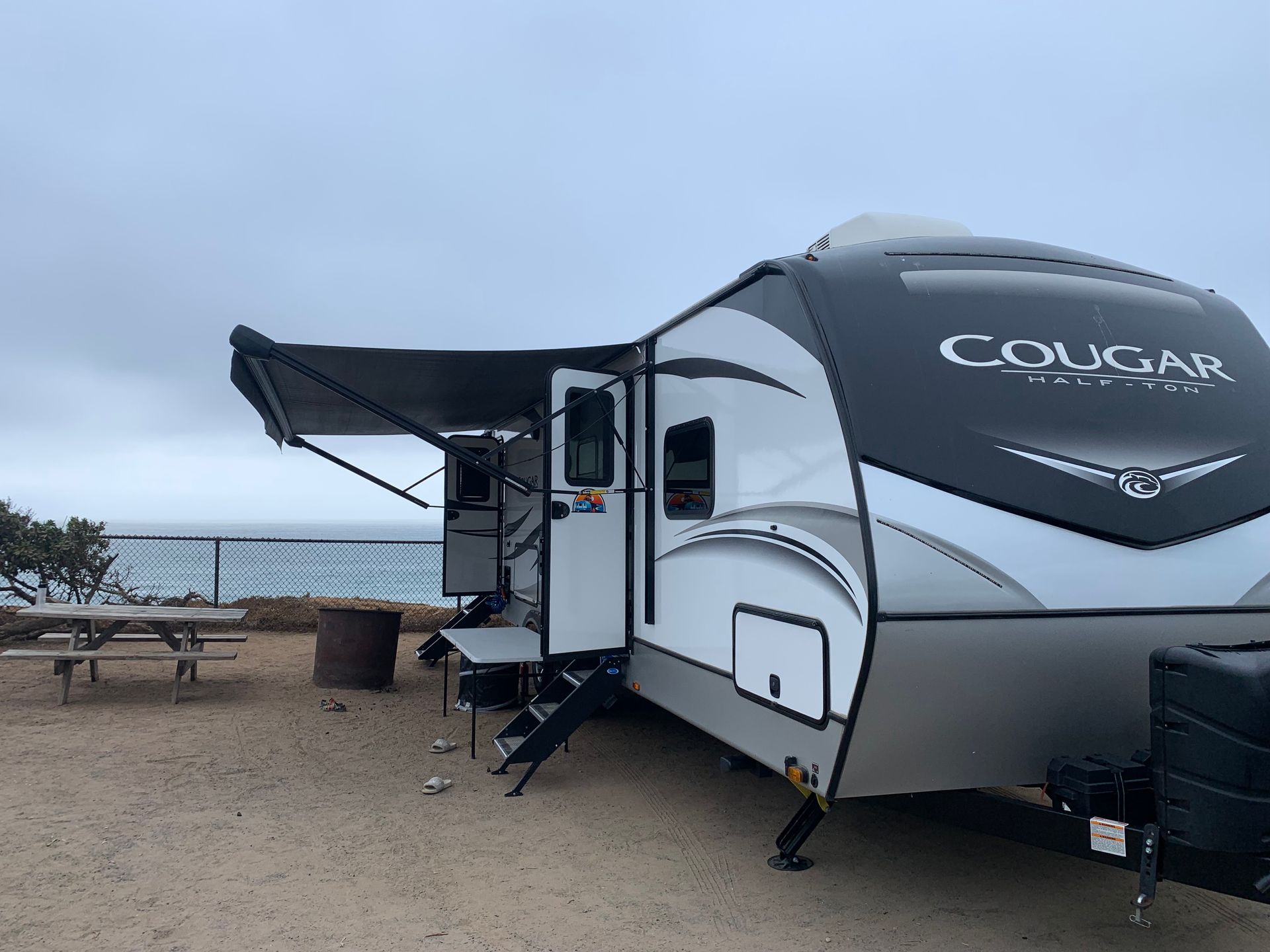 a cougar trailer is parked in front of a beach .