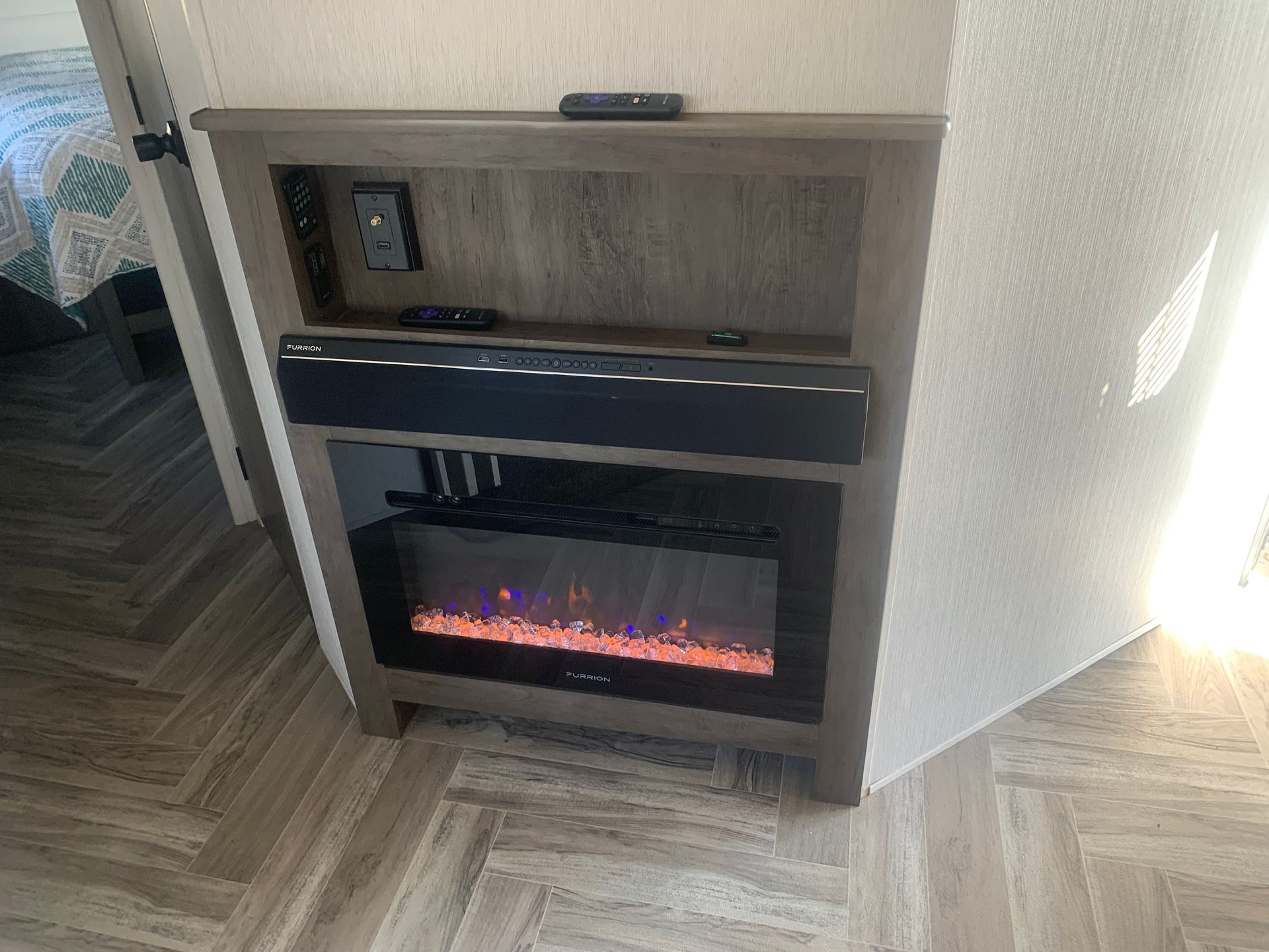 there is a fireplace in the corner of the room .