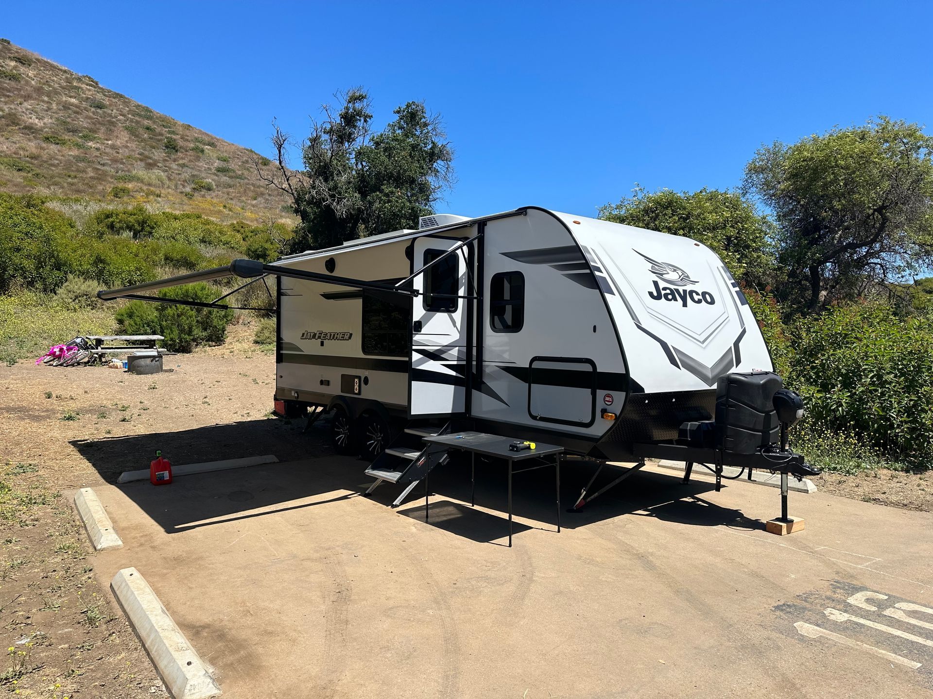 a jayco trailer is parked in a dirt lot .