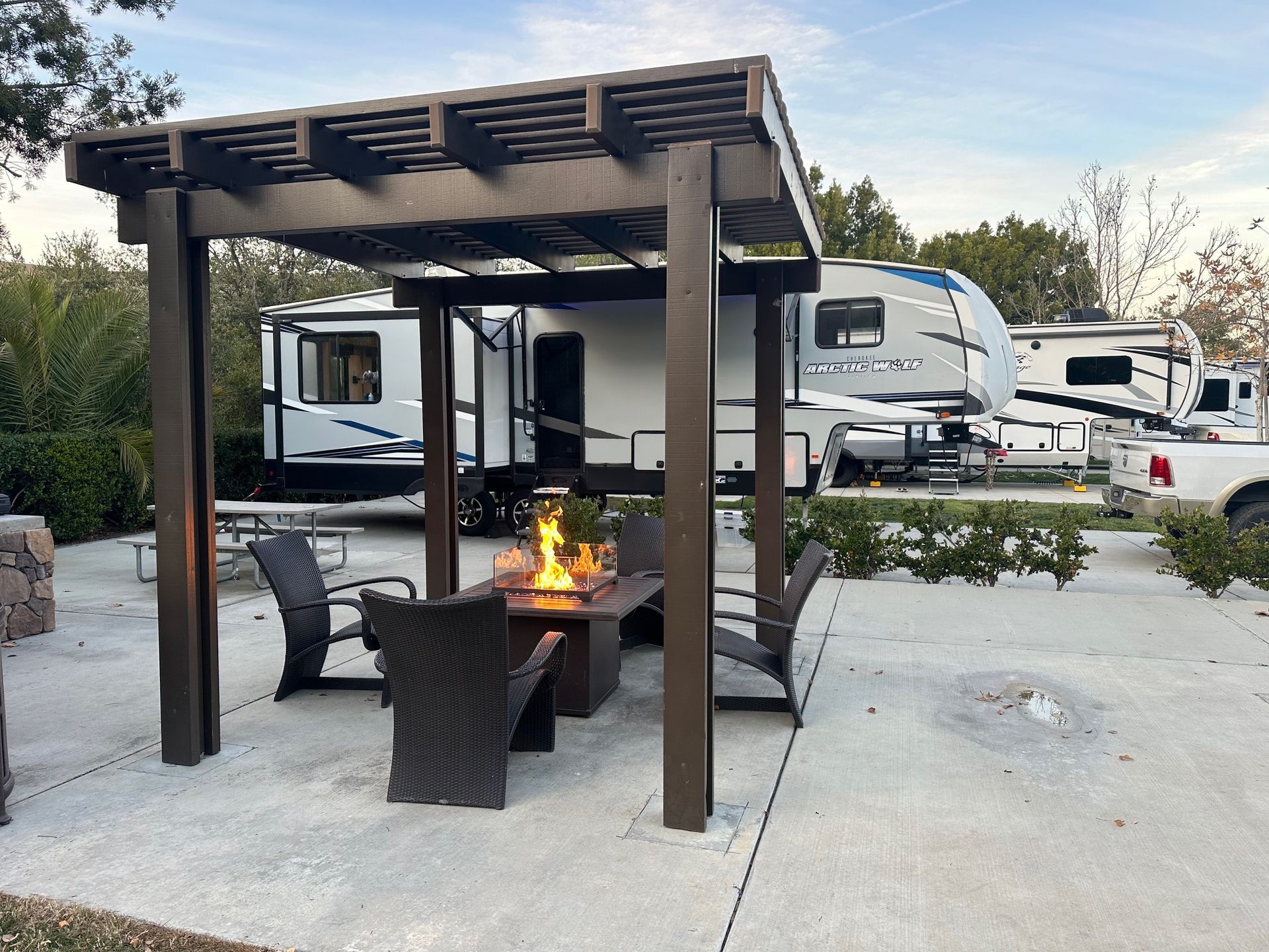 a patio with a table and chairs under a pergola .