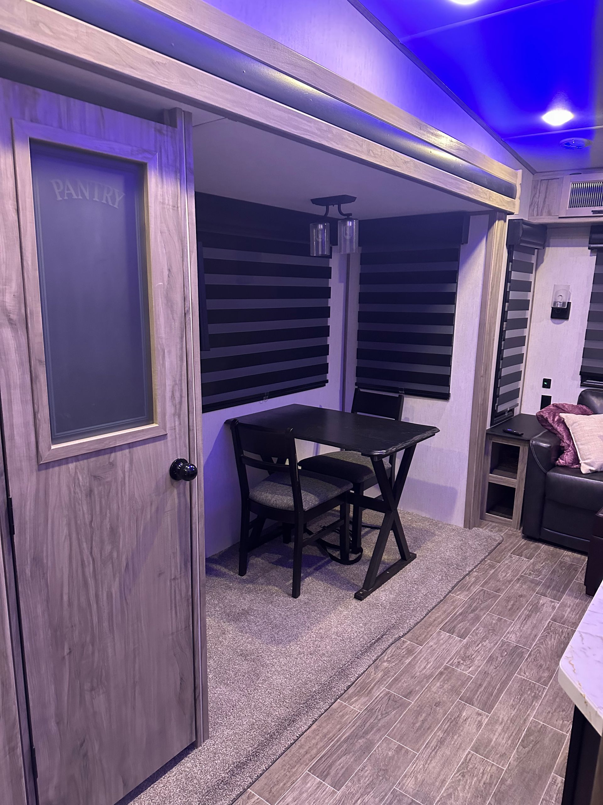 There is a table and chairs in the middle of the room.
