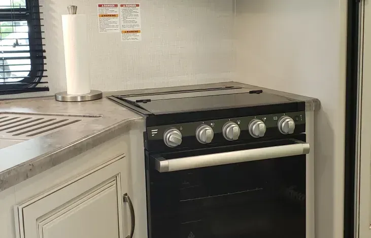 a stove top oven is sitting on top of a counter in a kitchen .