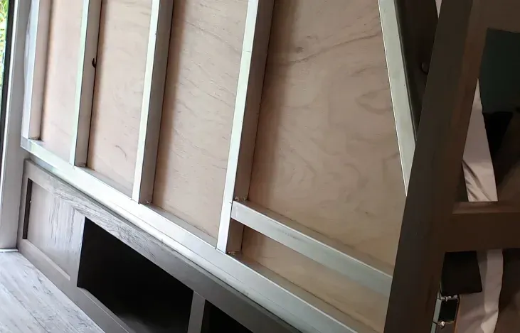 a wooden wall with a shelf underneath it