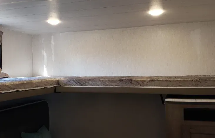 There is a bunk bed in the corner of the room.