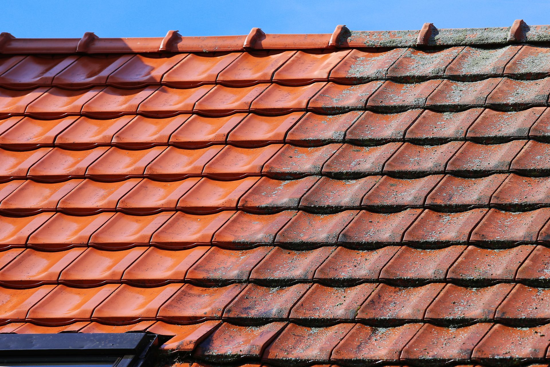 a picture of a roof before and after being cleaned