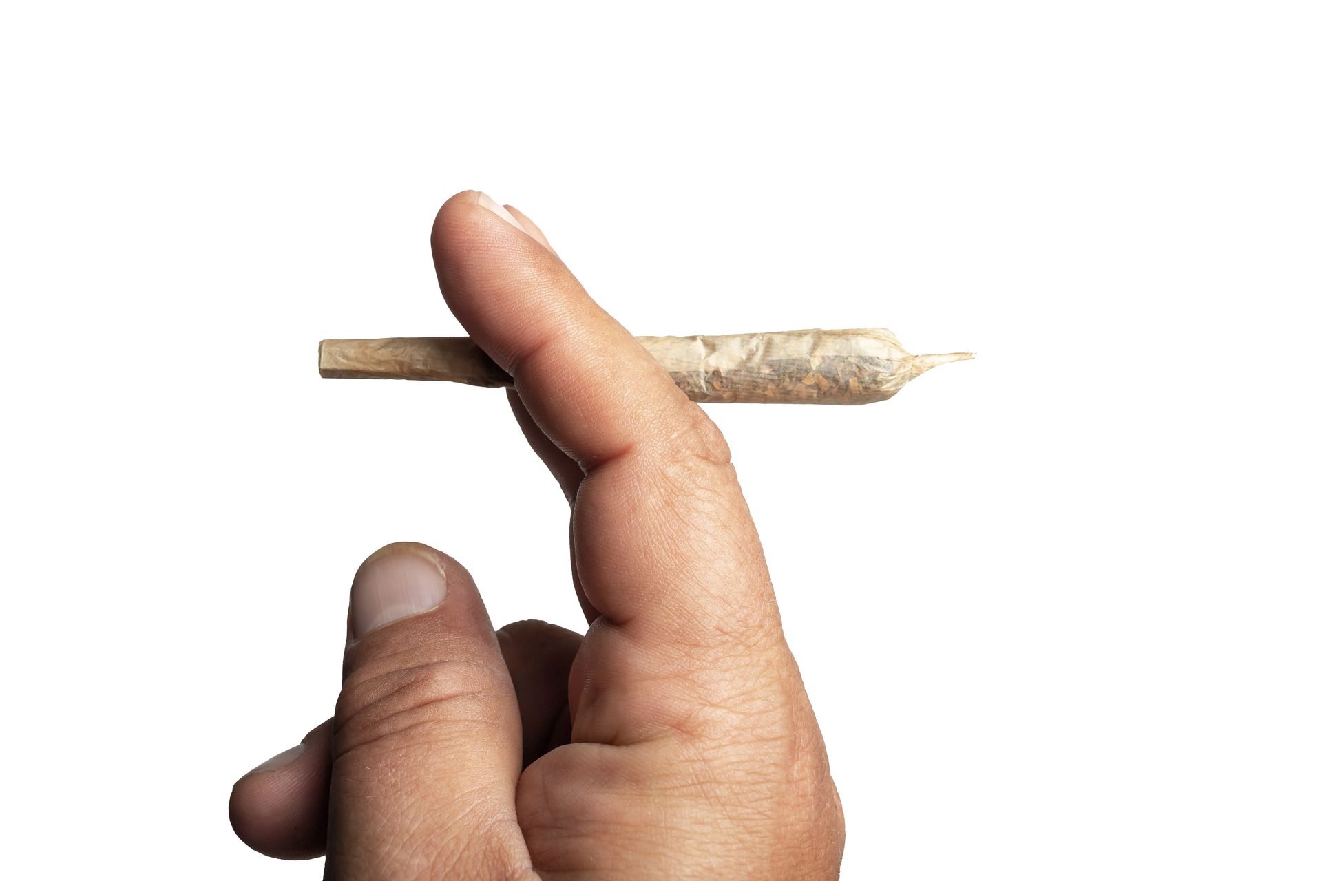 Hand holding a lit marijuana joint against a white background.
