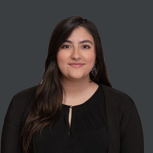 A woman with long hair is smiling and wearing a black shirt.