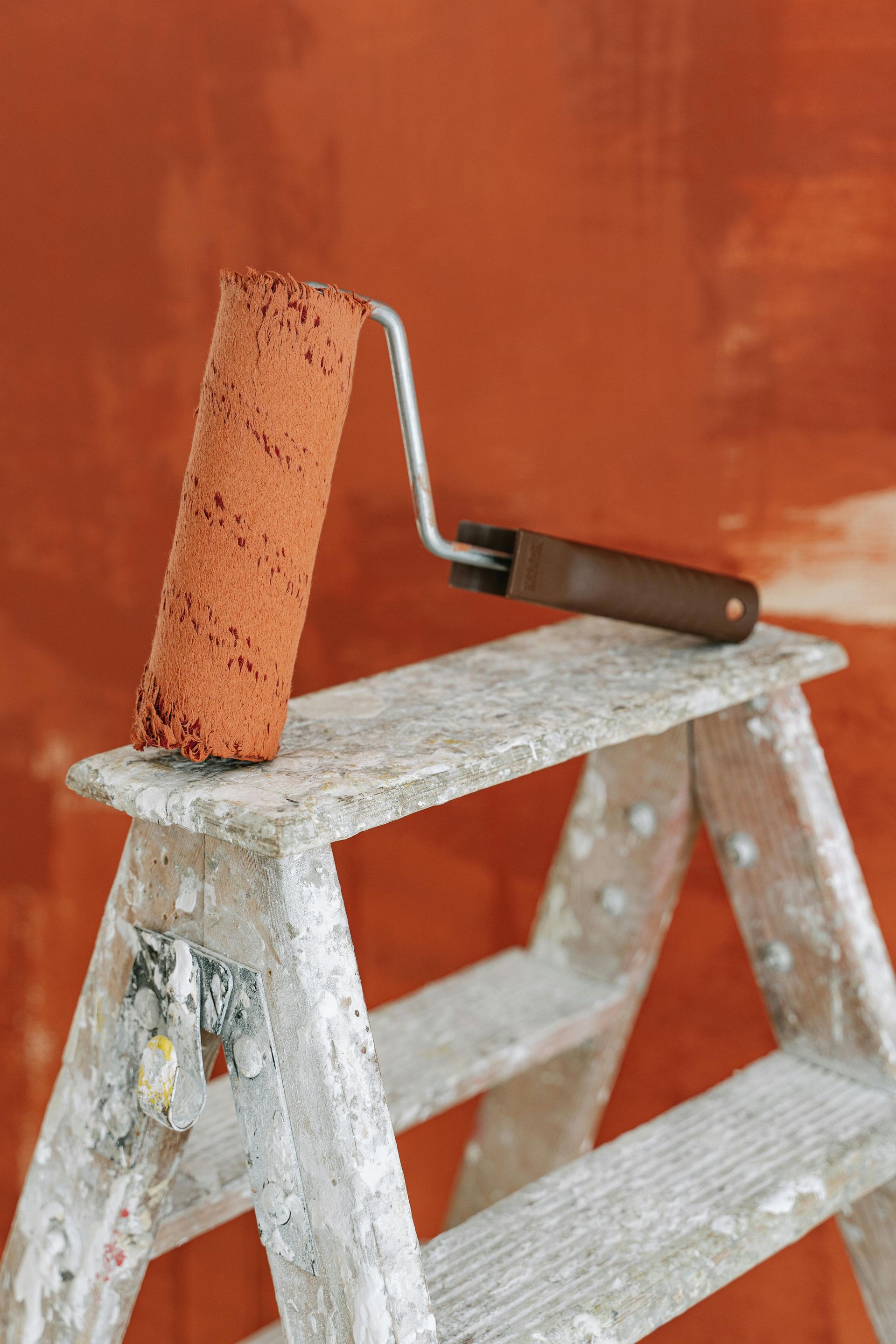 Paint in progress with roller and step ladder