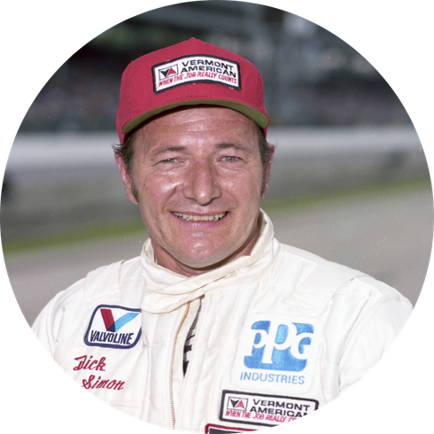 A man wearing a red hat and a white shirt with ppg industries written on it