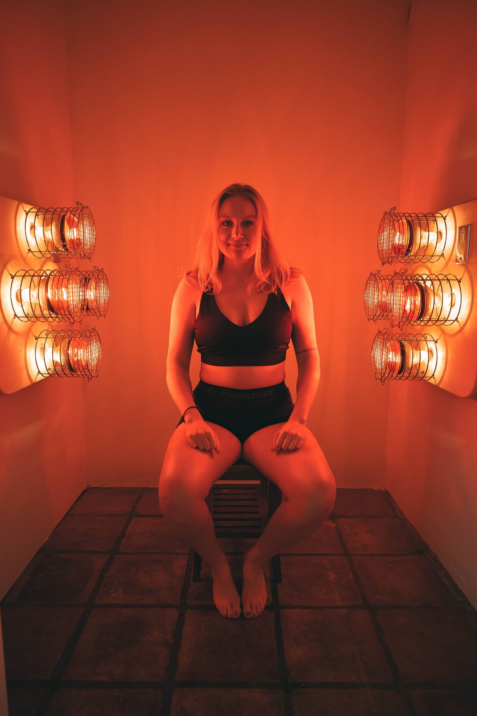 a woman sitting in a near infrared sauna