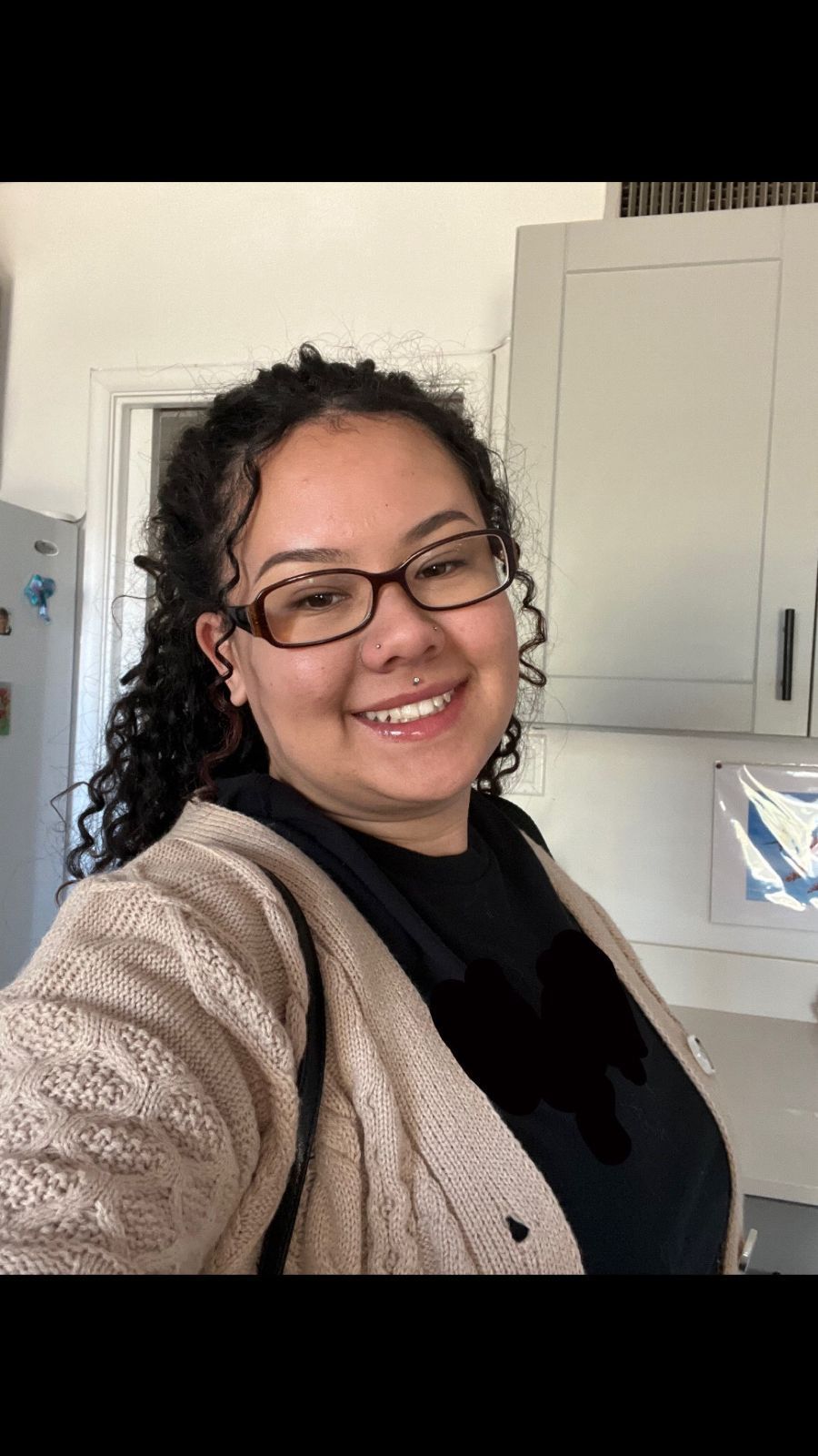 a massage therapist looking into the camera and smiling