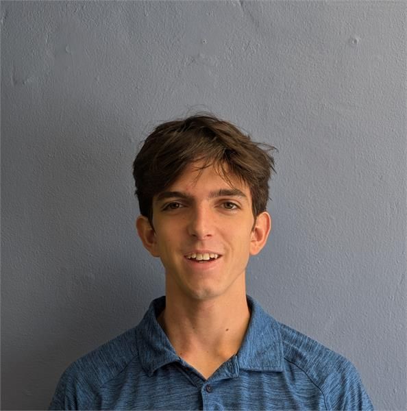 a massage therapist looking into the camera and smiling