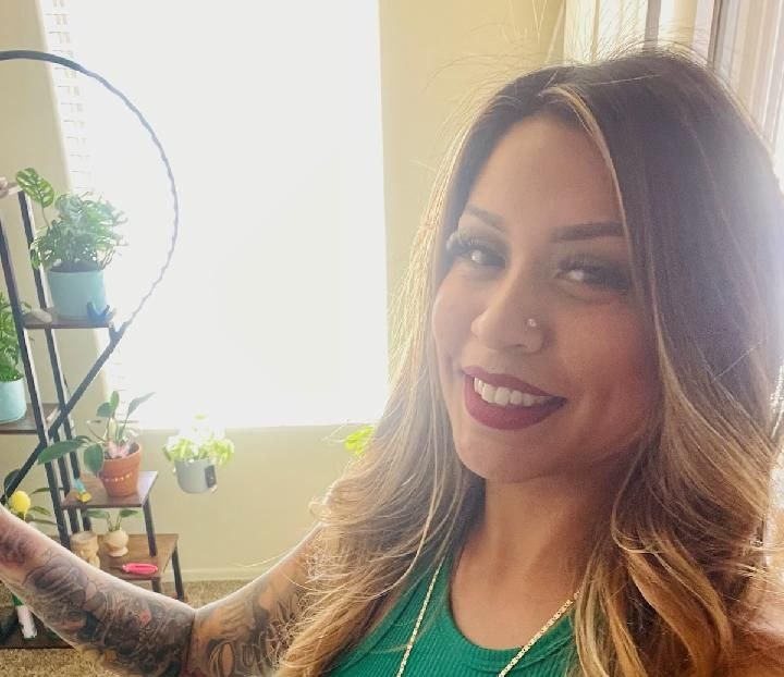 a massage therapist looking into the camera and smiling