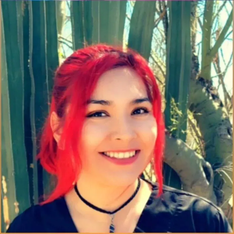 a massage therapist looking into the camera and smiling