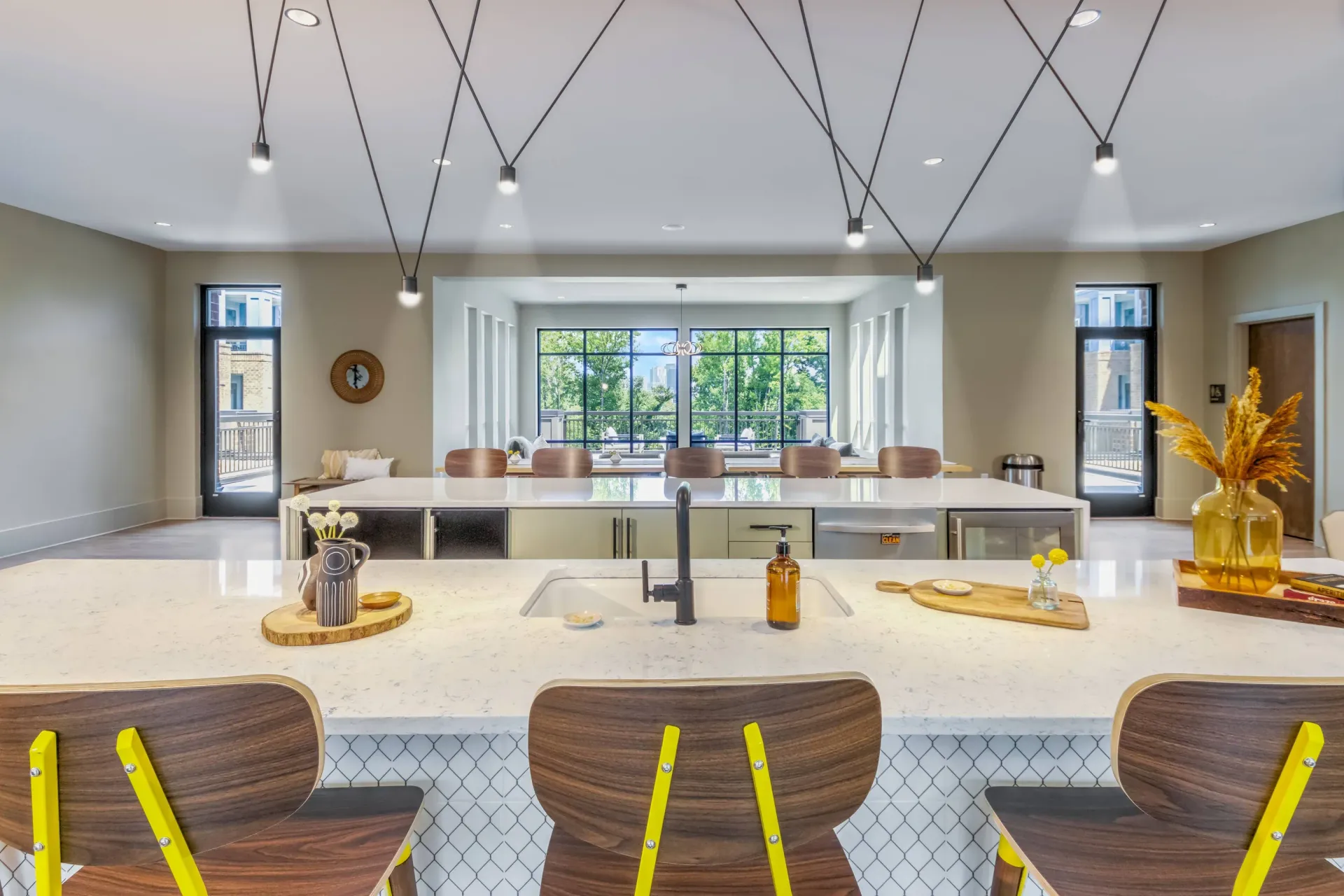 Open community kitchen with a large island, bar seating, and pendant lights.