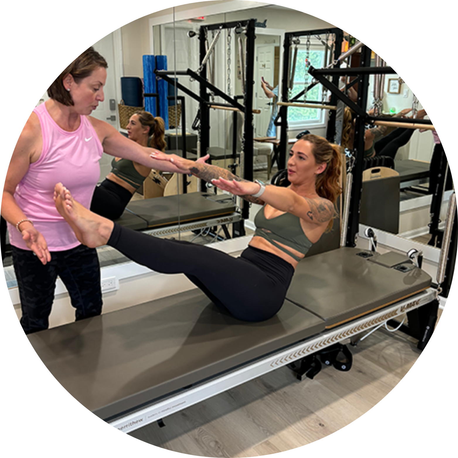 Pilates and Intuitive Energy Healing. Asha doing exercises on a pilates machine with client