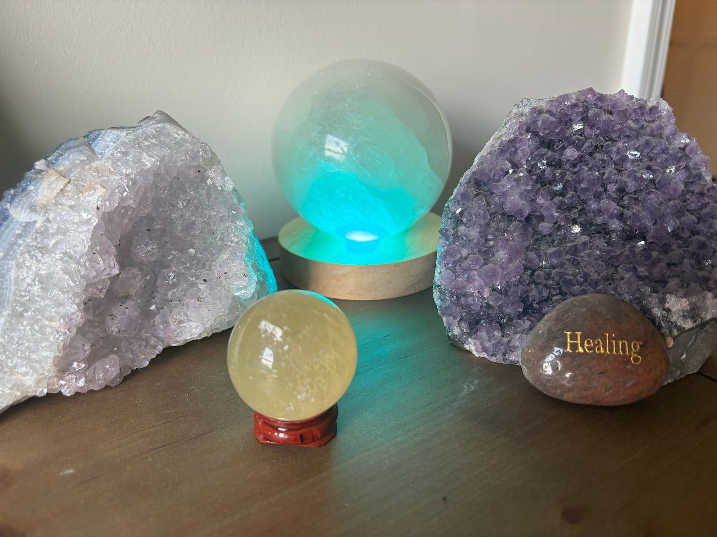 Pilates and Intuitive Energy Healing. group of crystals sitting on top of a wooden table.