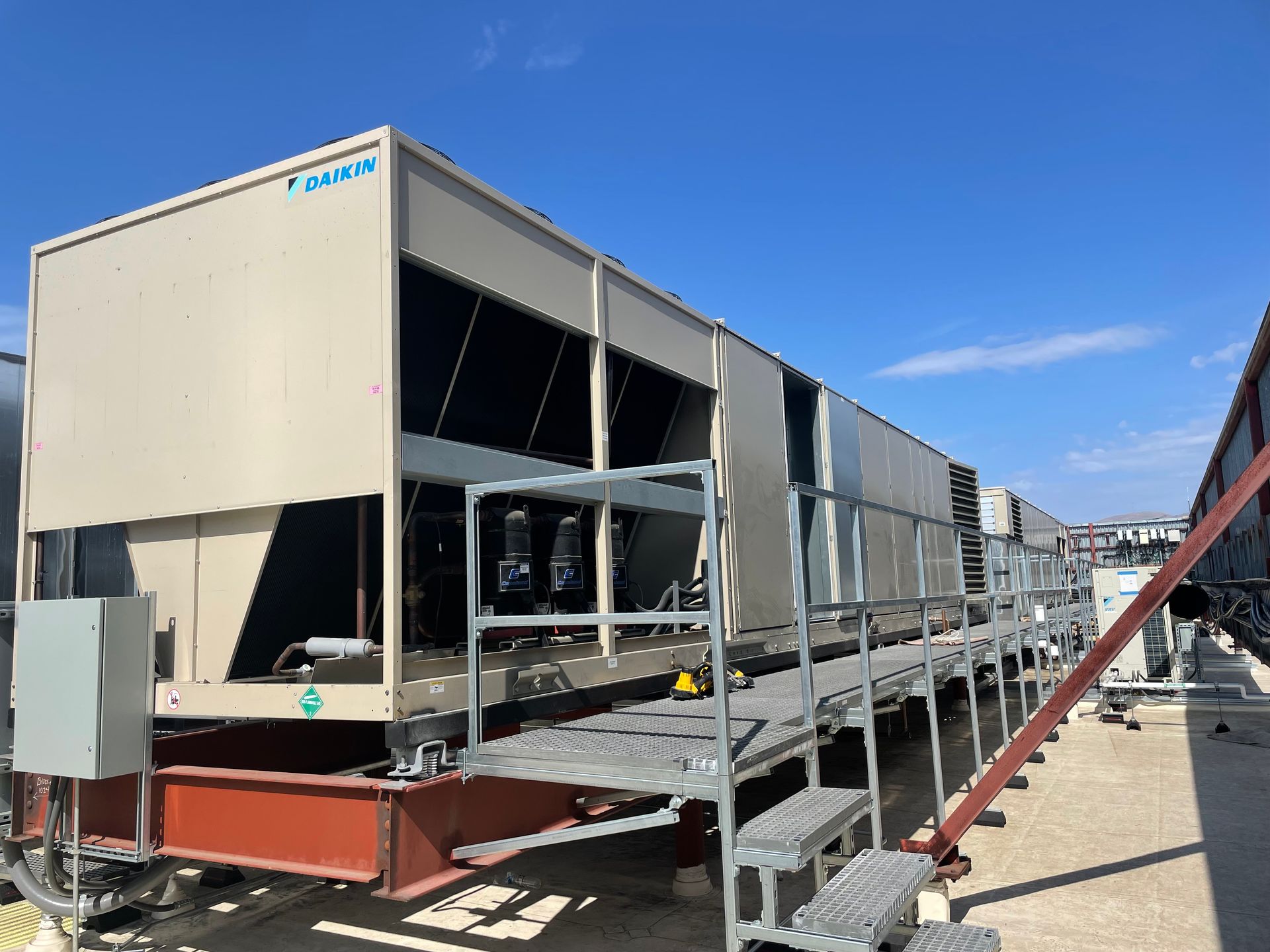 A large building with stairs leading up to it is sitting on top of a dirt field.