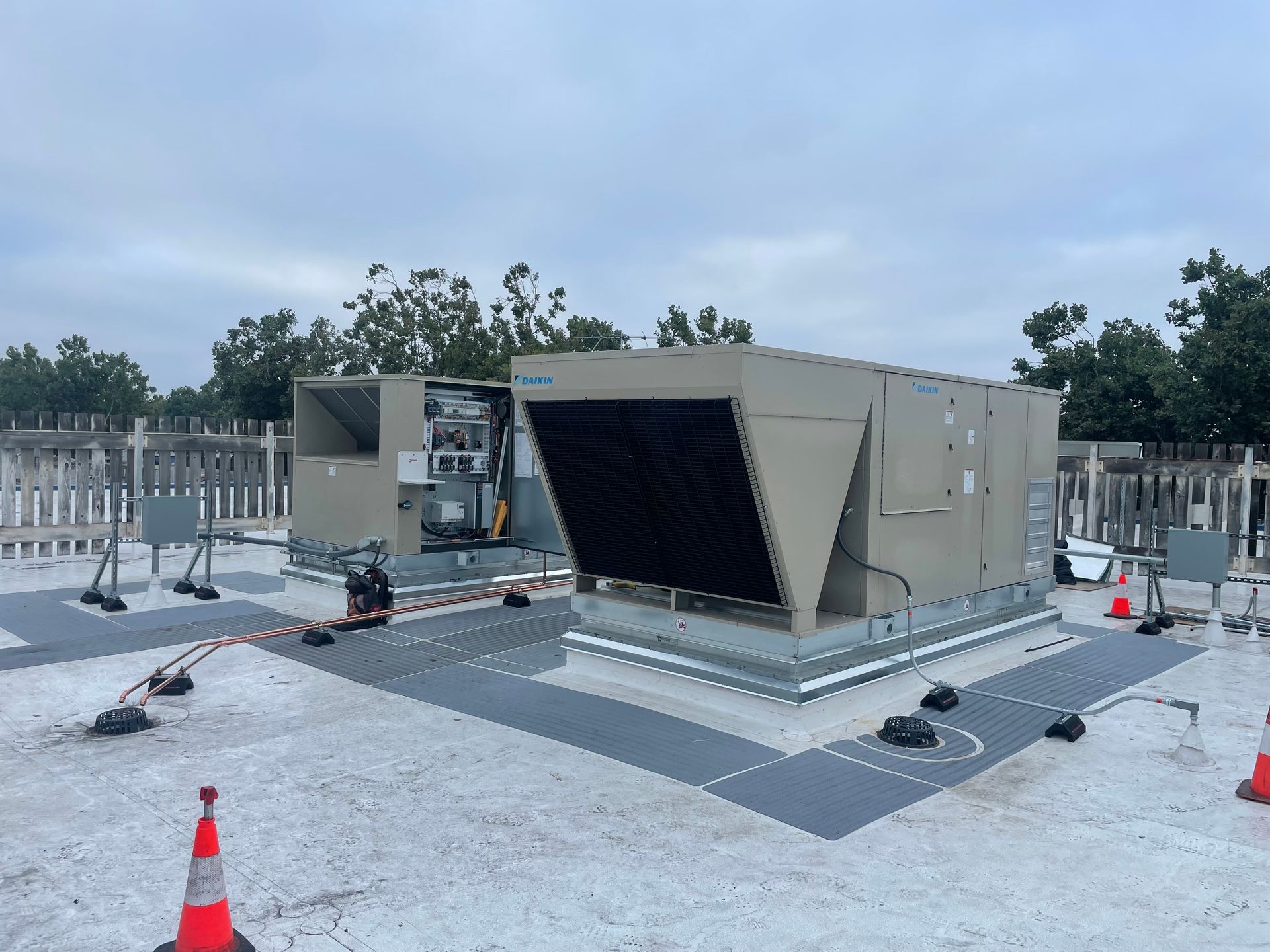 A large air conditioner is sitting on top of a roof.
