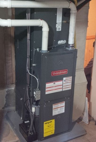 A goodman air conditioner is sitting in a basement