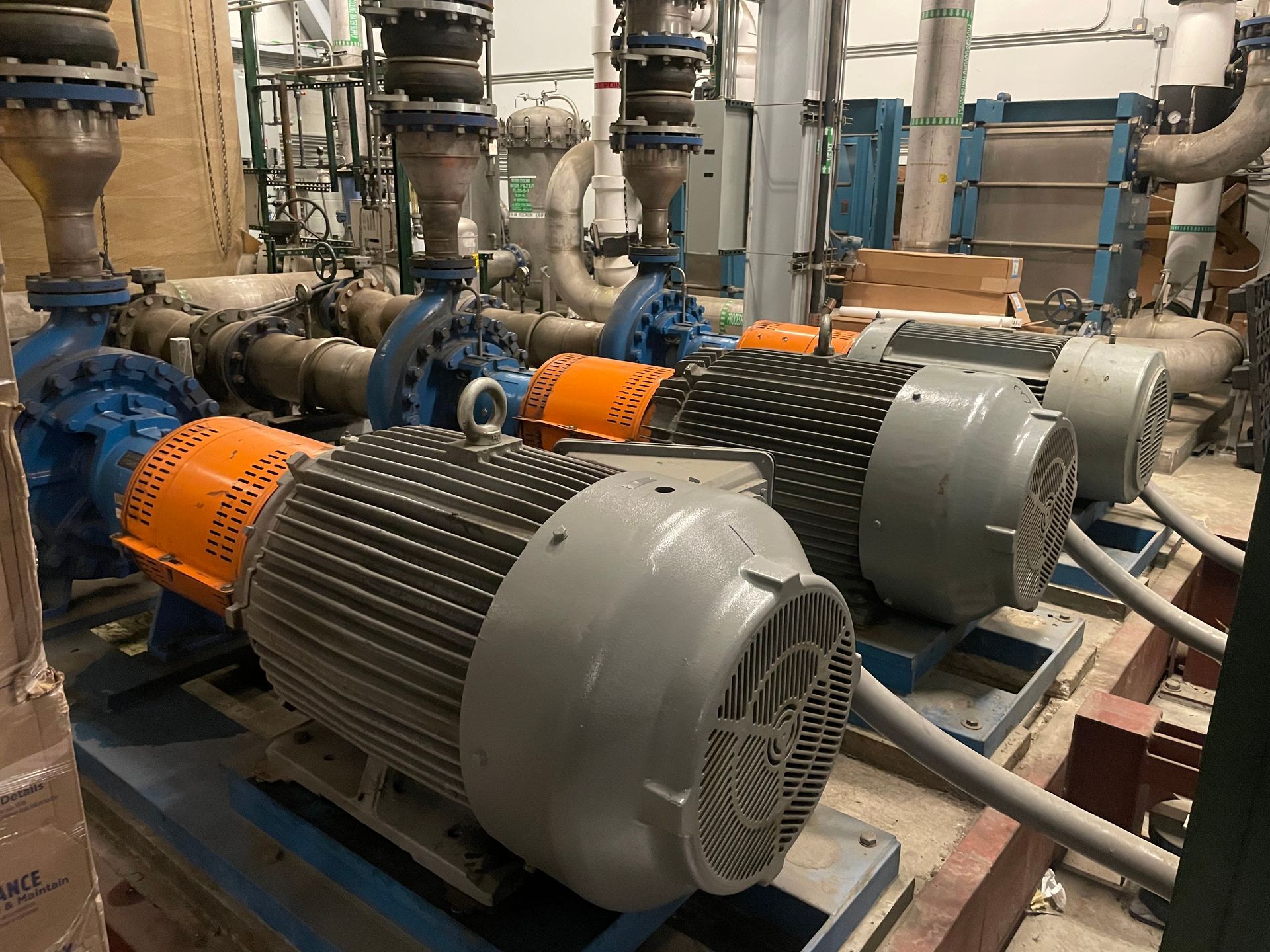 A bunch of pumps are sitting on top of each other in a factory.