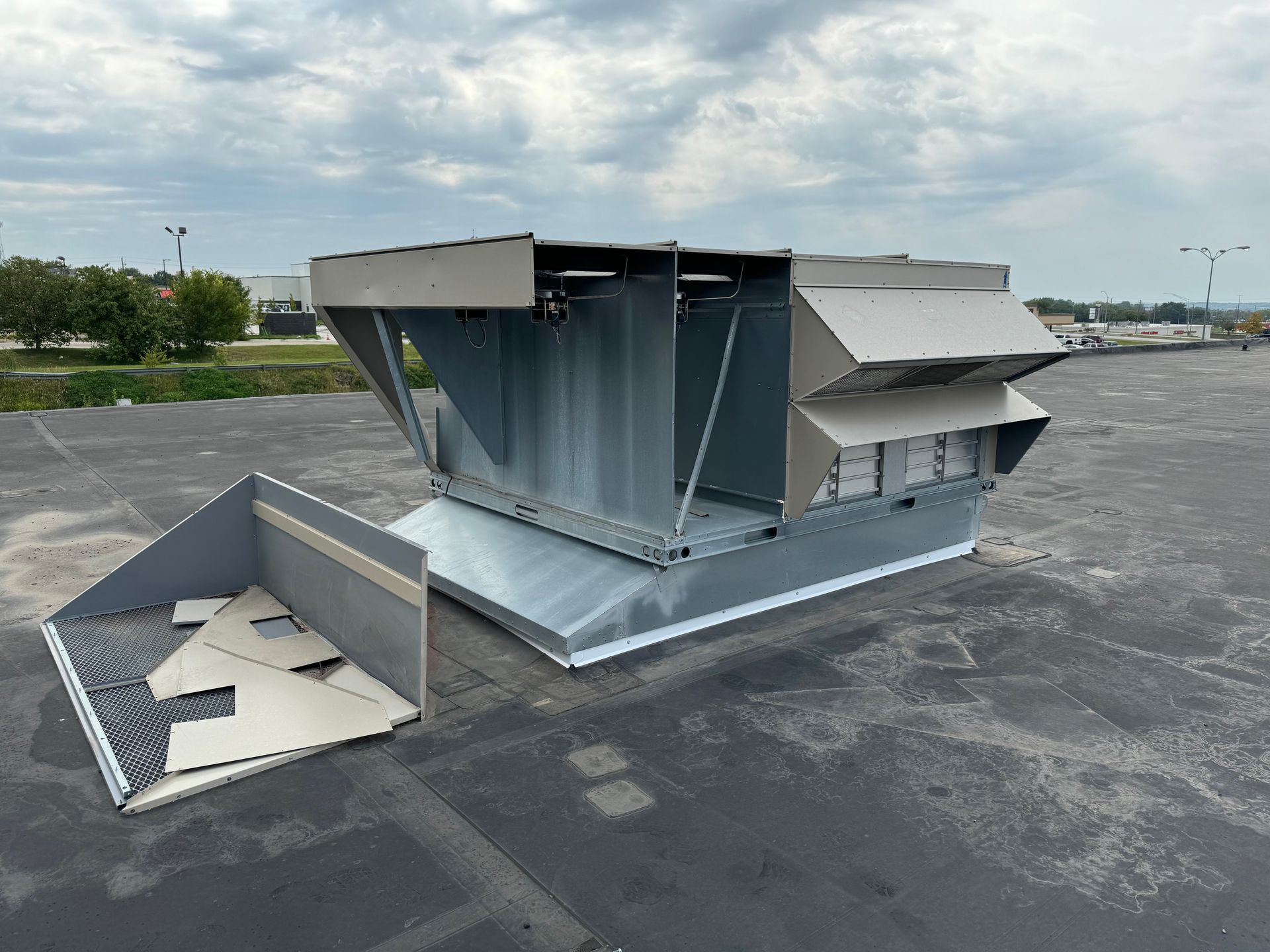 A large metal structure is sitting on top of a parking lot.