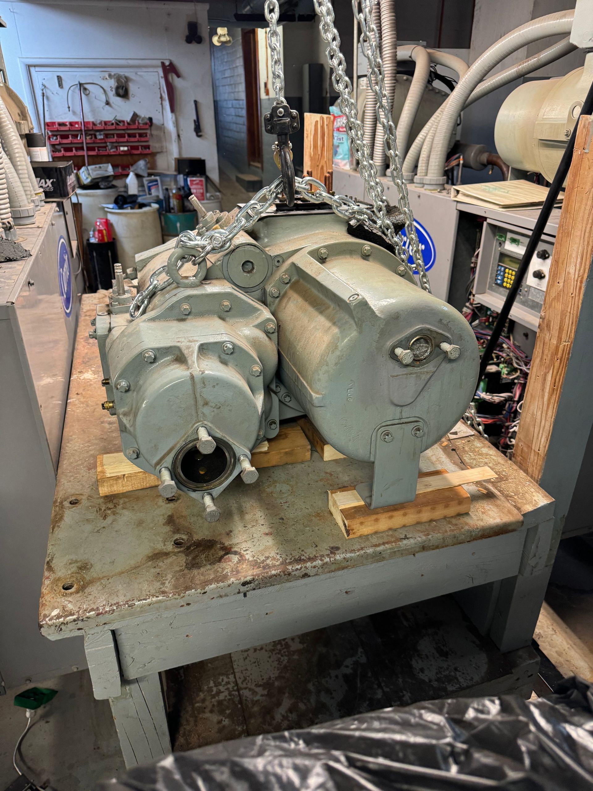 A large machine is sitting on top of a wooden table.