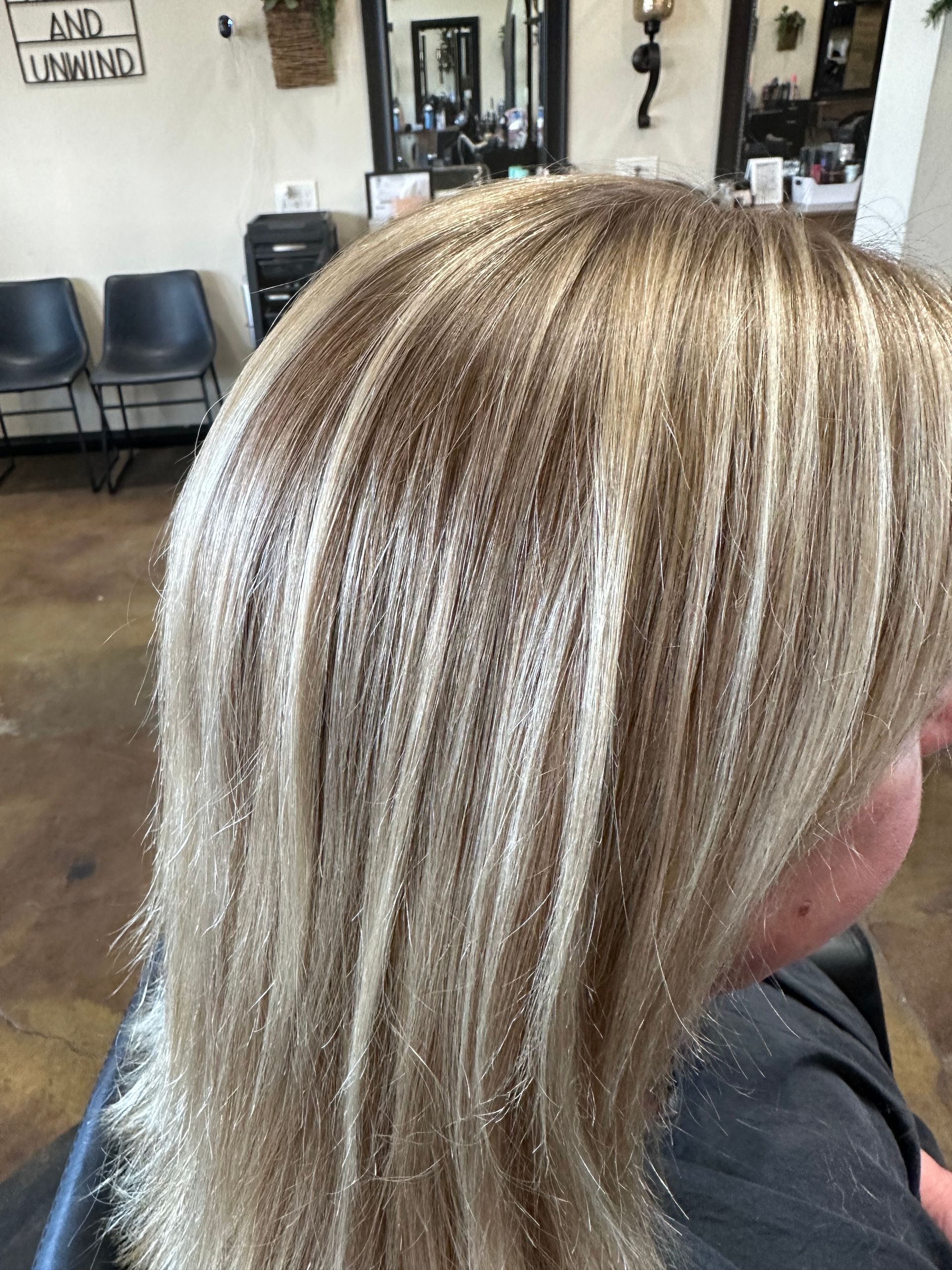 Blonde hair with textured, crimped highlights in a salon setting.