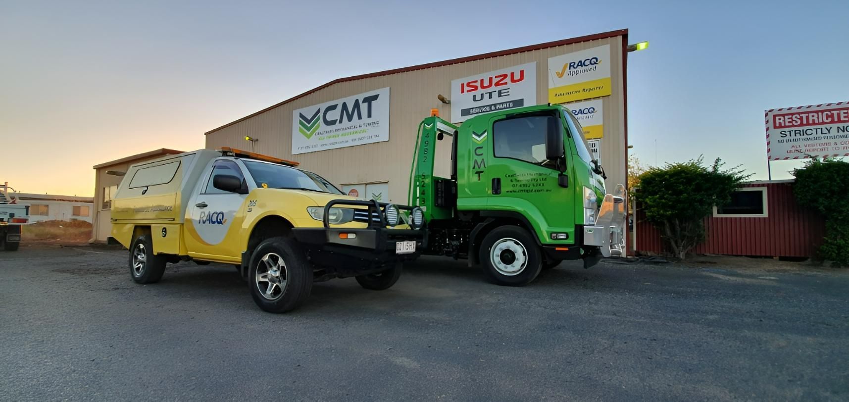 Two Tow Trucks Are Parked in Front of A Building — Coalfields Mechanical & Towing in Blackwater, QLD