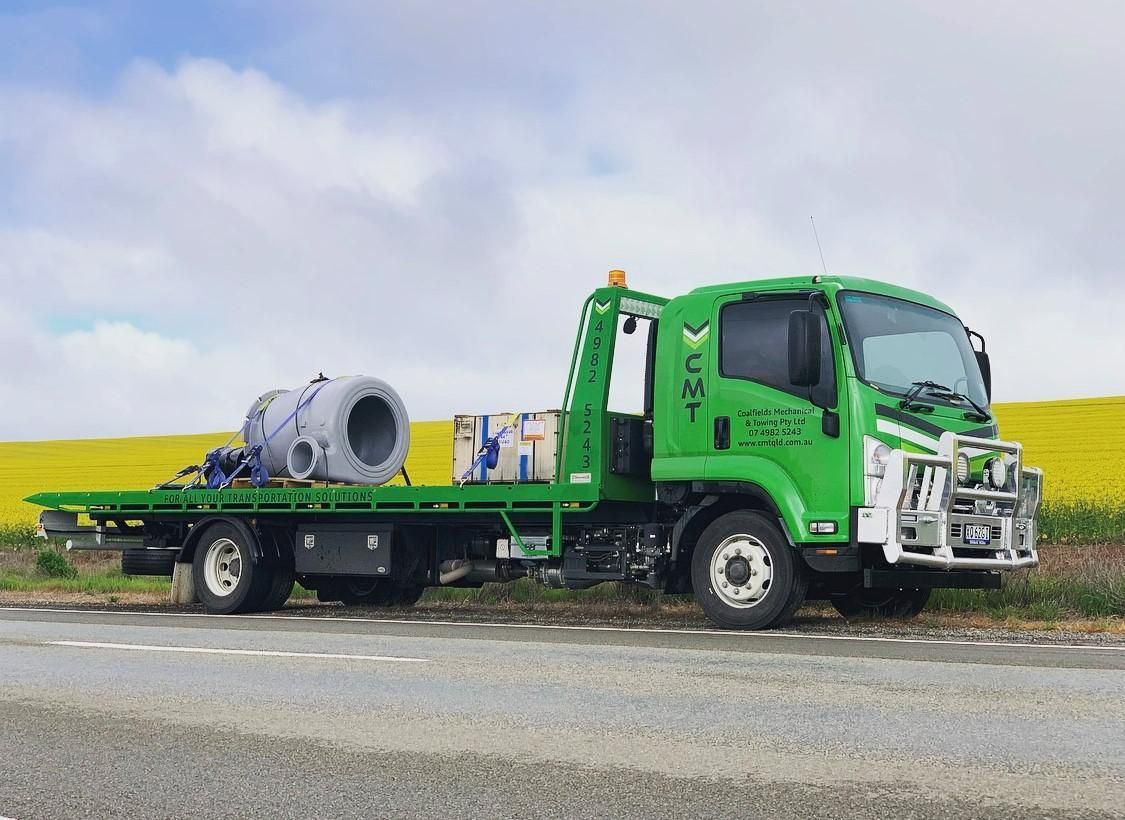 A Green Tow Truck Is Parked on The Side of The Road — Coalfields Mechanical & Towing in Blackwater, QLD 