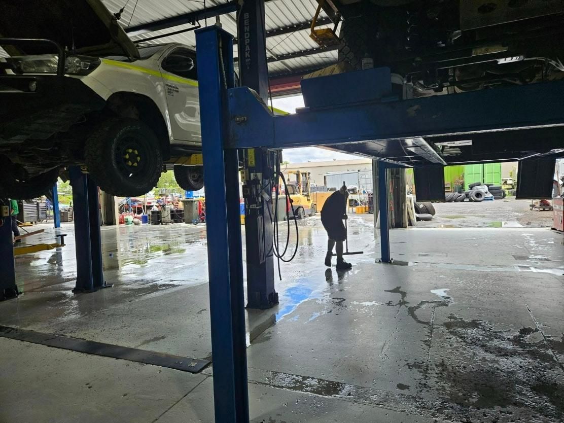 A Car Is Sitting on A Lift in A Garage — Coalfields Mechanical & Towing in Blackwater, QLD