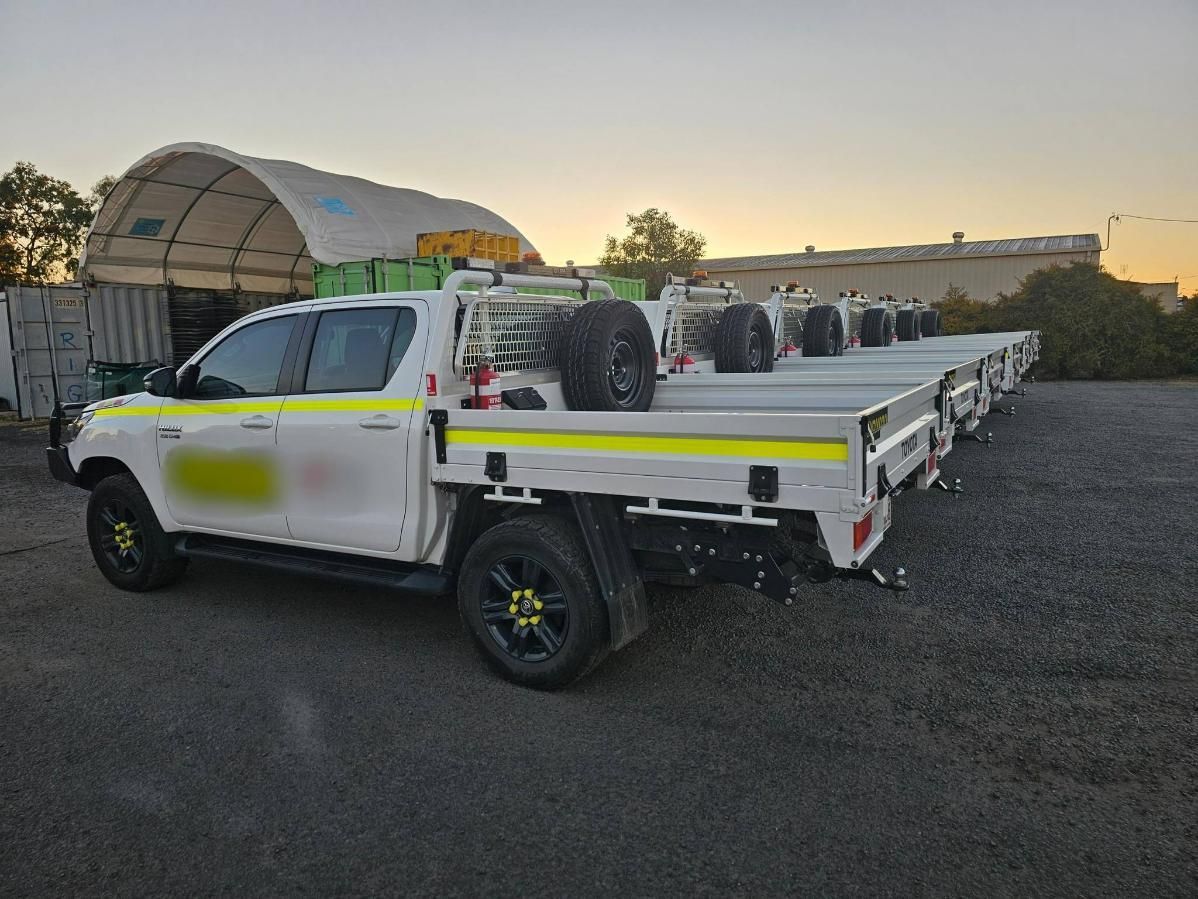 A White Truck with A Flat Bed Is Parked in A Parking Lot — Coalfields Mechanical & Towing in Blackwater, QLD