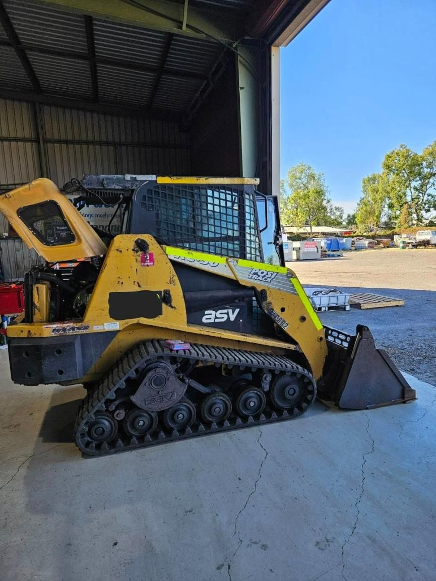 A Yellow and Black Tractor Is Parked in A Garage — Coalfields Mechanical & Towing in Blackwater, QLD