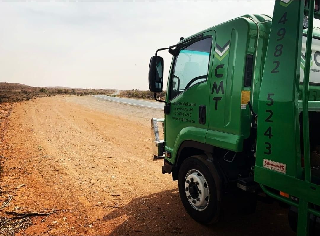 A Green Truck Is Parked on The Side of A Dirt Road — Coalfields Mechanical & Towing in Blackwater, QLD