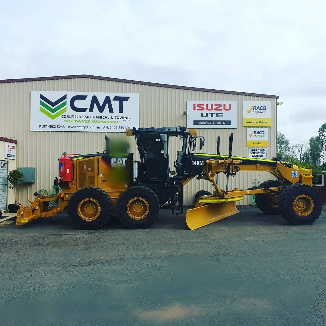 A Yellow Tractor Is Parked in Front of A Building that Says CMT — Coalfields Mechanical & Towing in Blackwater, QLD