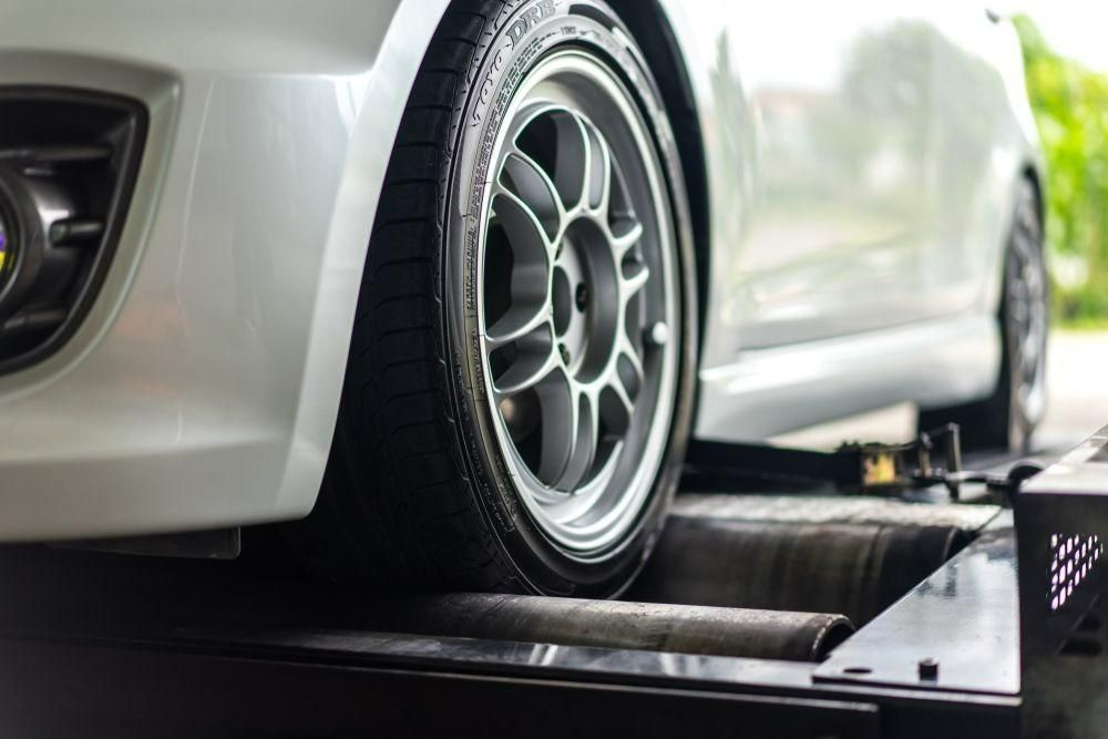 A White Car Is Being Tested on A Machine — Coalfields Mechanical & Towing in Blackwater, QLD