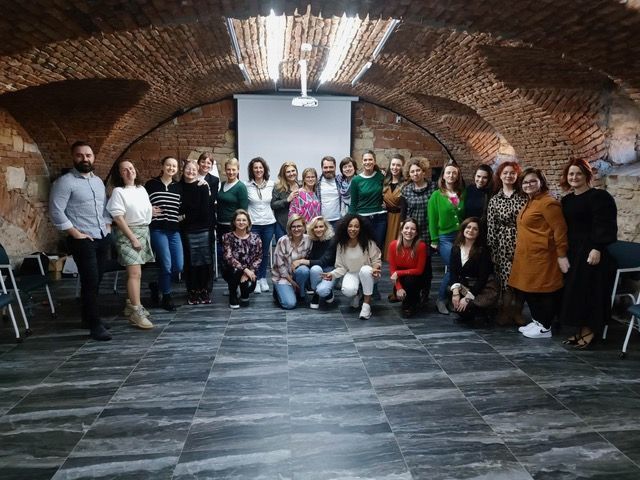 A group of people are posing for a picture in a room.