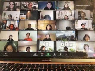 A group of people are having a video call on a laptop computer.