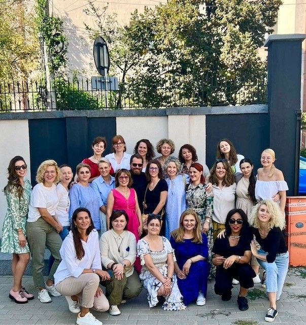 A large group of women are posing for a picture