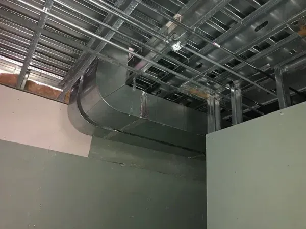 HVAC ductwork installed in ceiling and around walls of a commercial space.