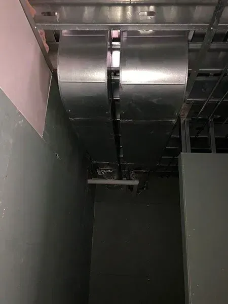 Galvanized metal HVAC ductwork installed in a commercial space, running along the ceiling.