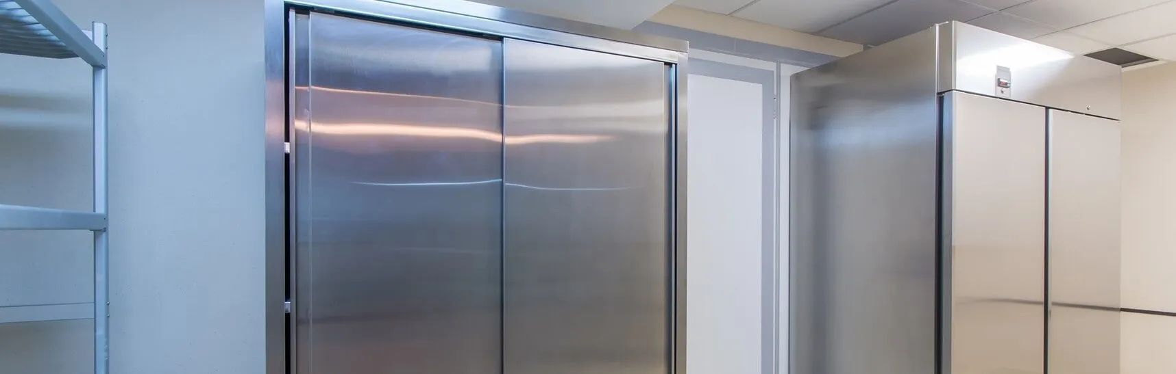 A Row of Stainless Steel Refrigerators Are Lined Up in a Room — Todd Hayes Refrigeration & Air Conditioning Pty Ltd in Kyogle, NSW
