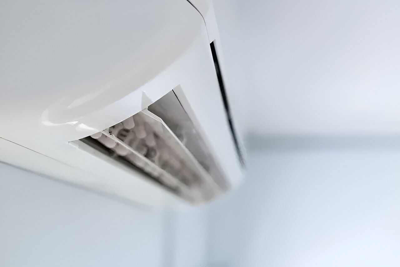 A Close Up of a White Air Conditioner Hanging on a Wall — Todd Hayes Refrigeration & Air Conditioning Pty Ltd in Kyogle, NSW