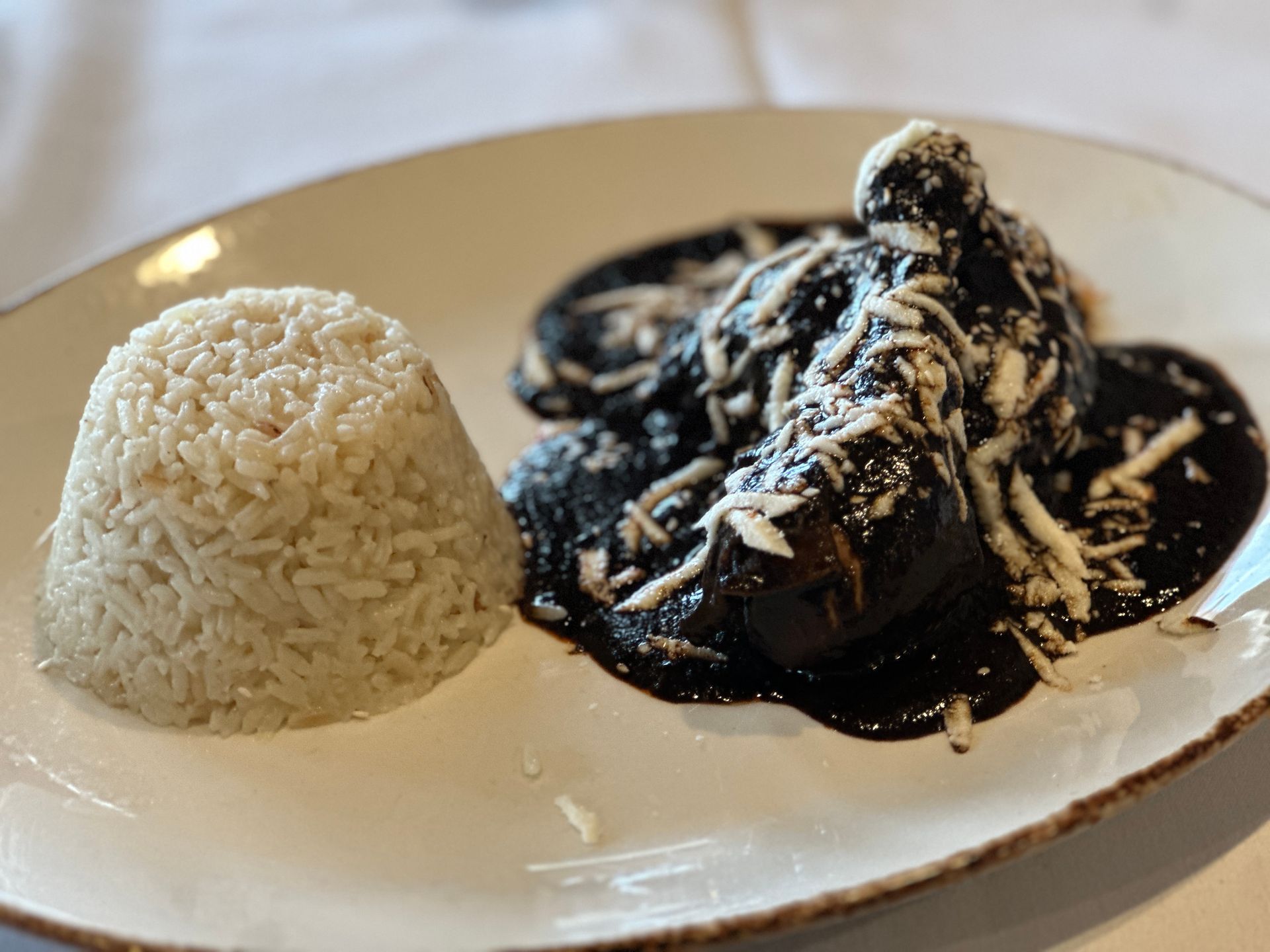 A plate of food with rice and sauce on a table.