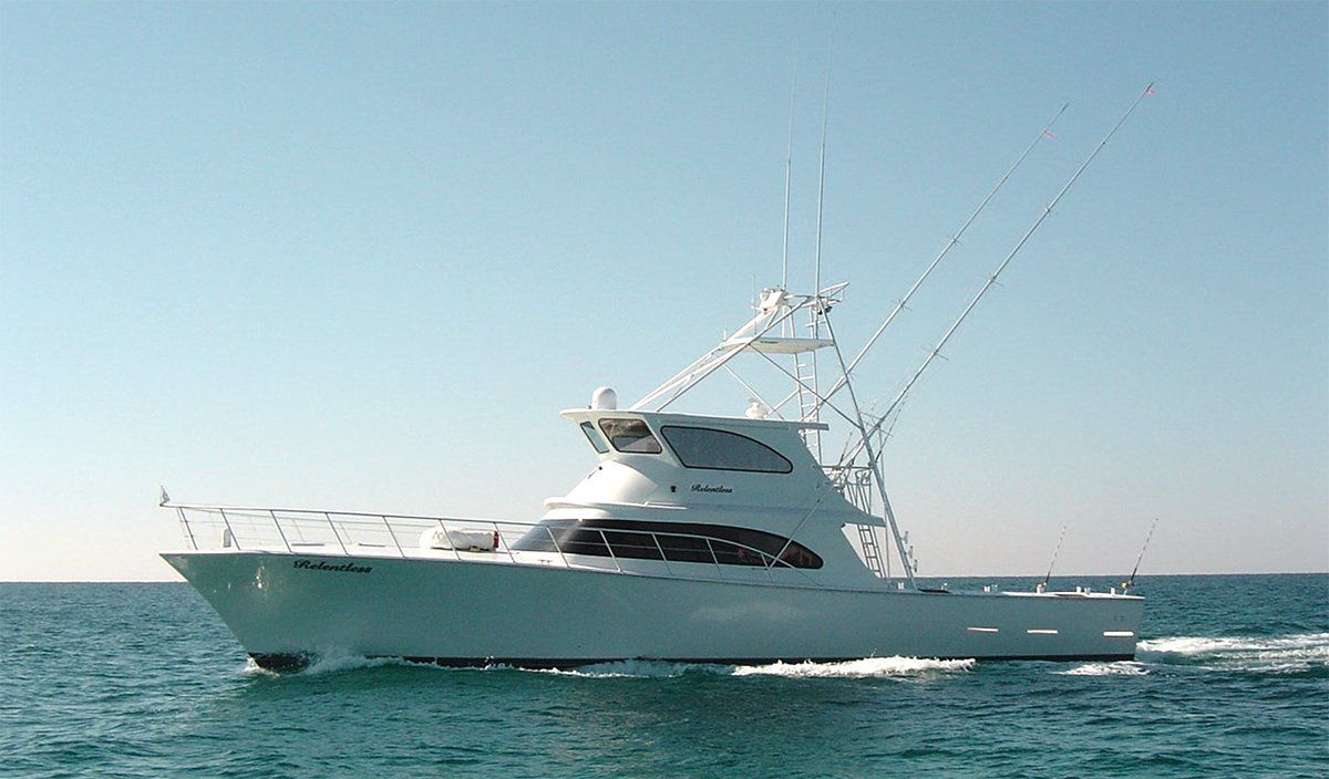 A large white boat is floating on top of a body of water.