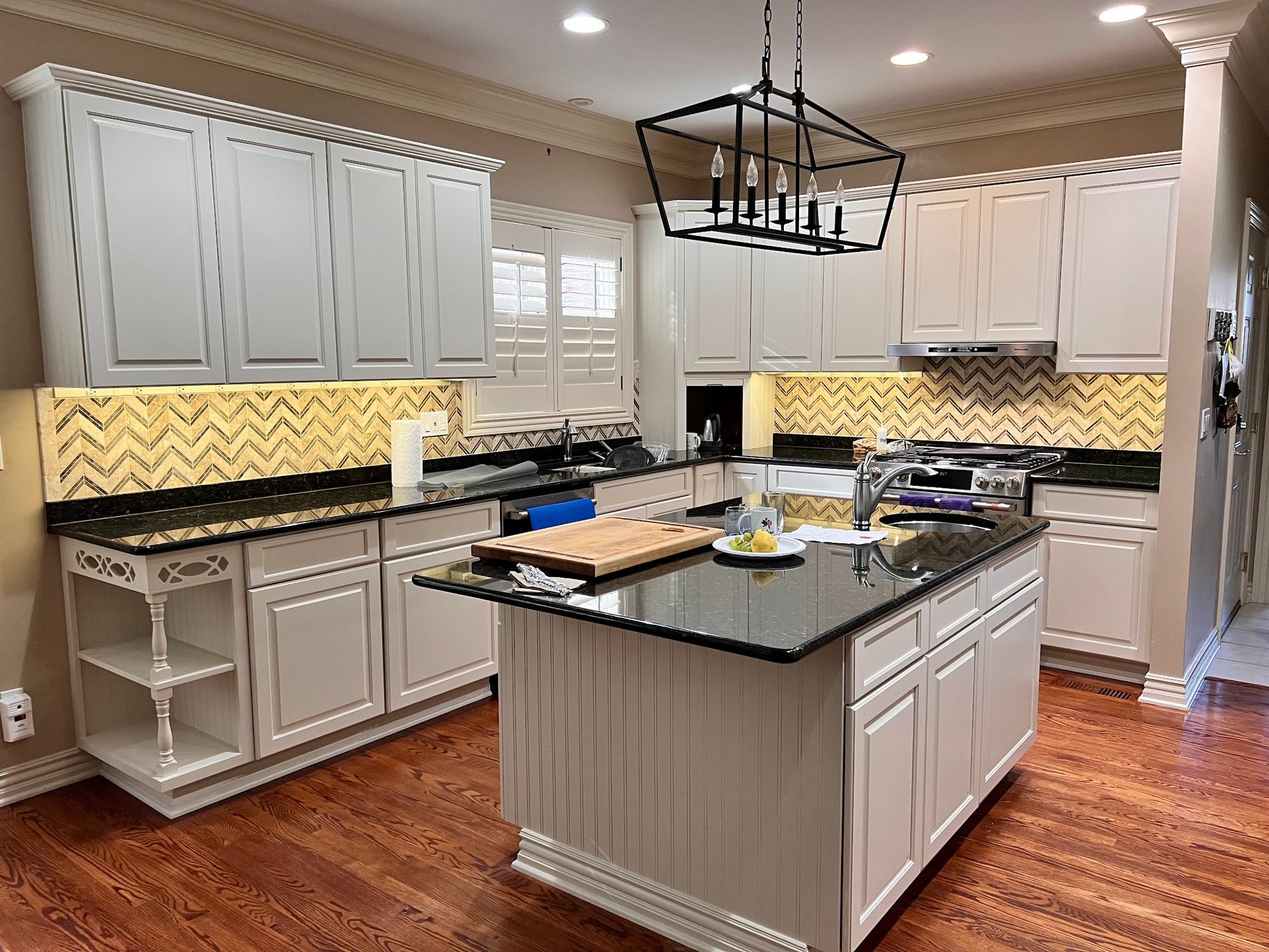 Kitchen with stainless steel appliances, light brown cabinets, and white countertop.