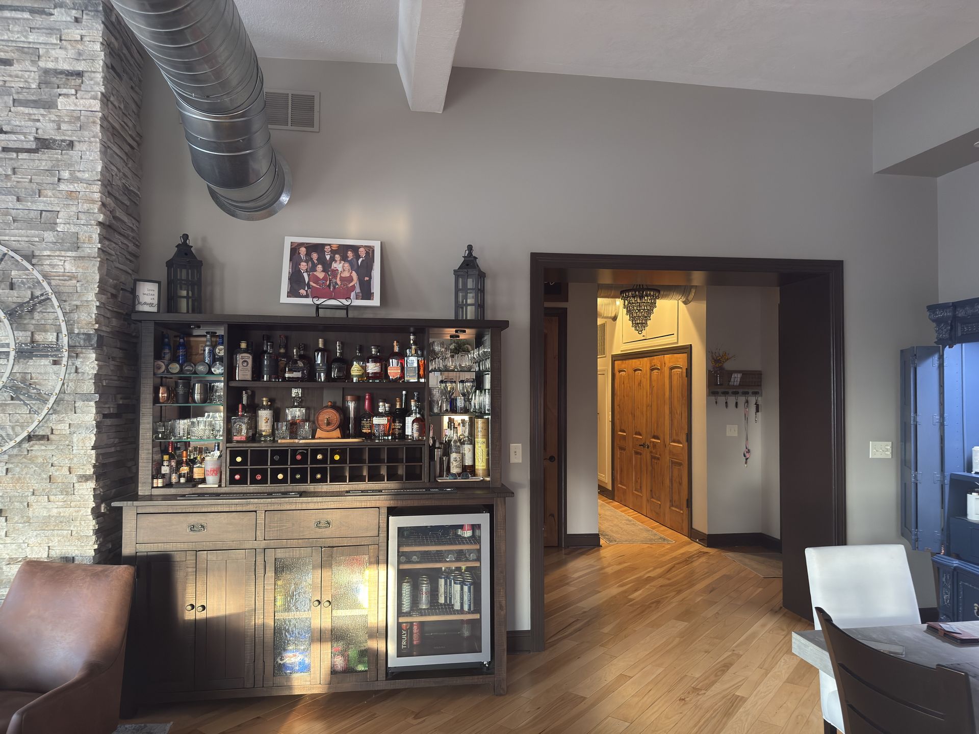 Hand painting a white wall with a blue paint roller.