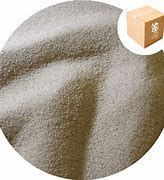 A close up of a pile of sand with a box in the background.